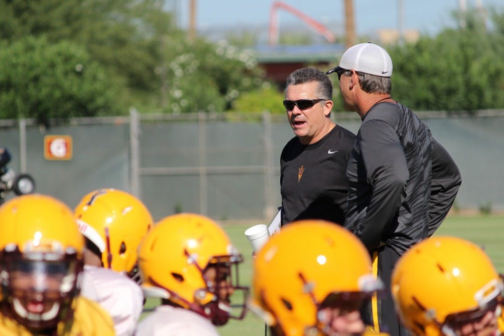 ASU coach Todd Graham watches over his players as they stretch at the beginning of practice on Thursday, Sept. 18.
