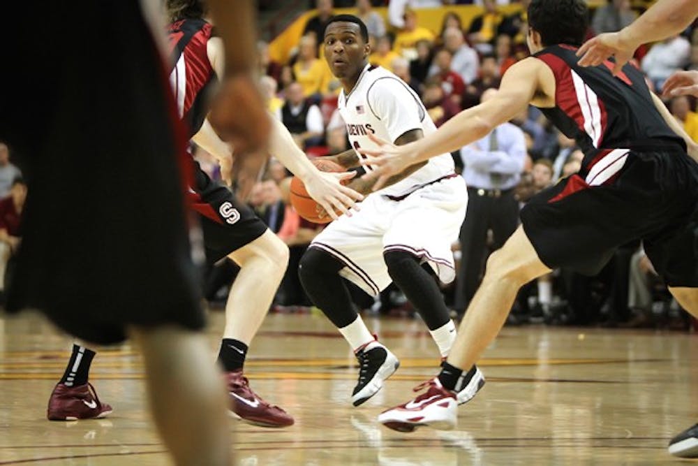 Redshirt freshman Jahii Carson looks through the Stanford defense for an open teammate on Feb. 9. ASU went with a smaller lineup in the second half which put a lot defensive responsiblity on Carson. (Photo by Sam Rosenbaum)
