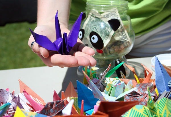 HIGH-FLYING HOPE: Sophomore Spanish major Brittany Lenart holds one of the 2,000 cranes that were folded by the Circle K International club on Wednesday. Donations for the cranes will be given to the American Red Cross to support the relief effort in Japan. (Photo by Lisa Bartoli)