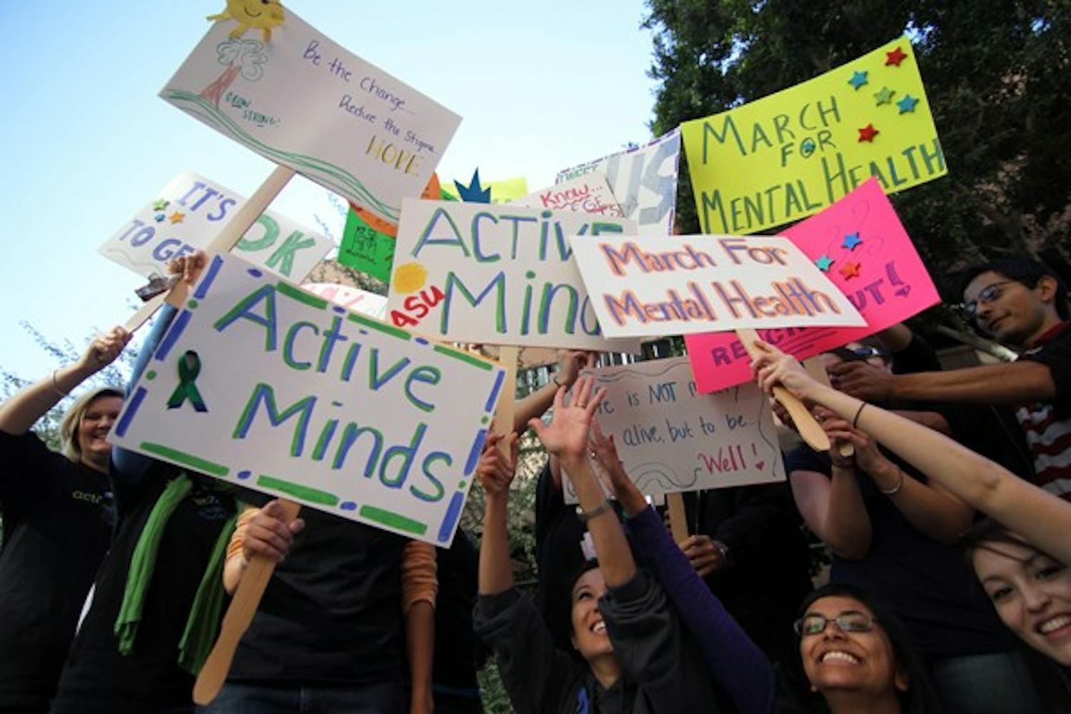 Students from the Active Minds at ASU club pose with their signs after a mental health awareness march around the Downtown campus Wednesday morning, where they chanted, "Listen! Talk! Reach out!" to bring awareness to the many mental health issues students deal with. (Photo by Lisa Bartoli)