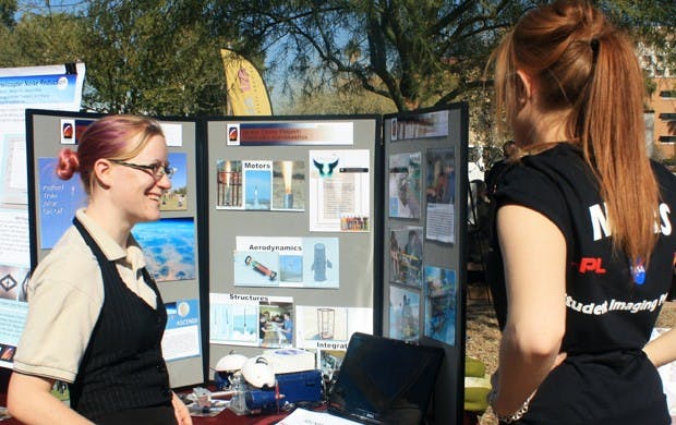 Emily McBryan explains to ASU senior Liz Dyer about the Robotics Team’s project.  Photo by Noemi Gonzalez.