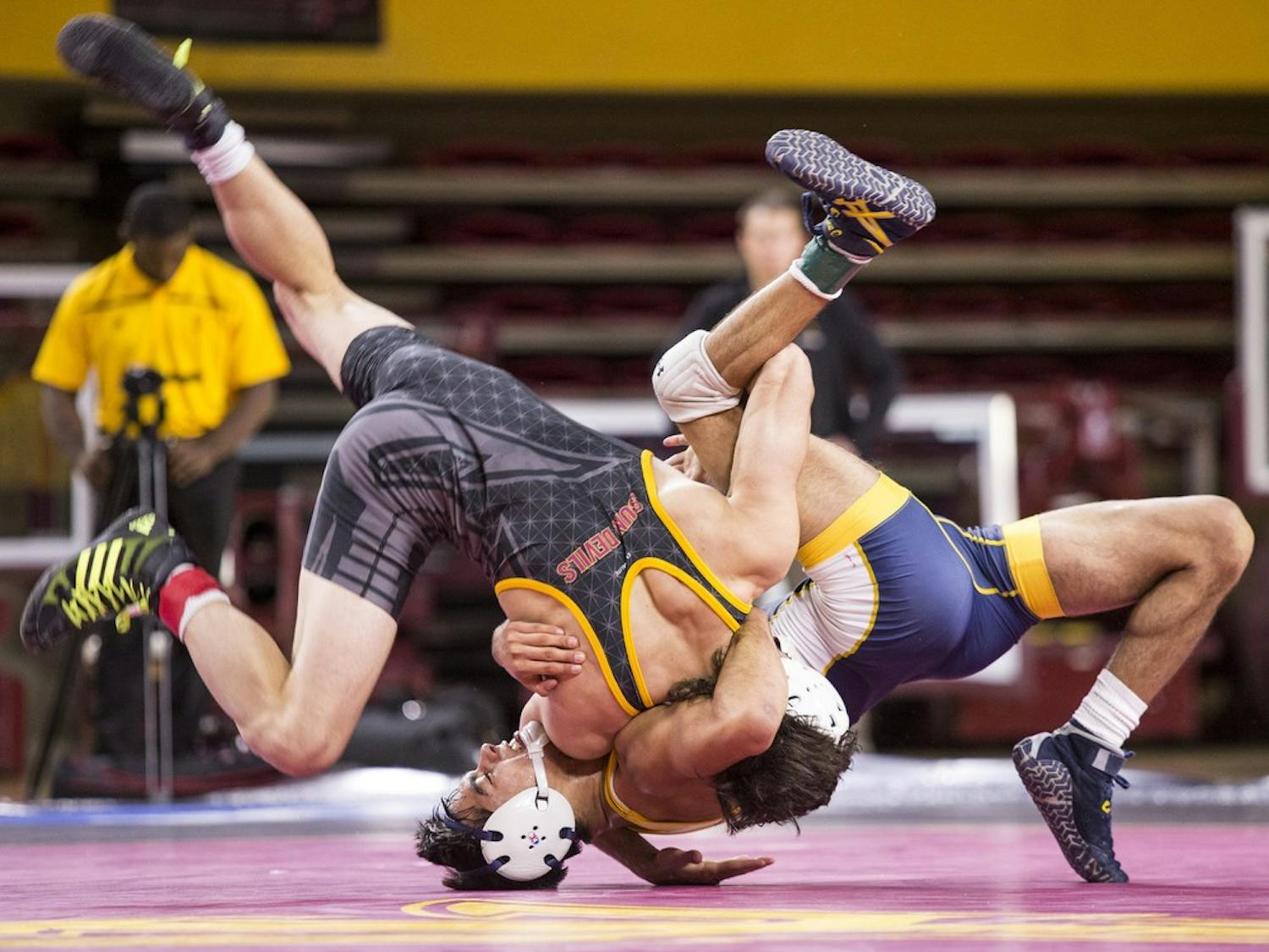 ASU's Robbie Mathers, left, flips around UNC's Sonny Espinoza in a 141-pound matchup during a meet against the University of Northern Colorado at Wells Fargo Arena in Tempe on Thursday, Nov. 12, 2015. The Sun Devils took down the UNC Bears 21-14.