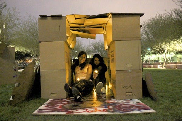 CARDBOARD CREATION: Andrea Leon (Left) and Jessa Short (Right) show their support for homeless and hunger awareness week by building forts in the Hassayampa Courtyard Thursday night. (Photo by Samuel Rosenbaum)