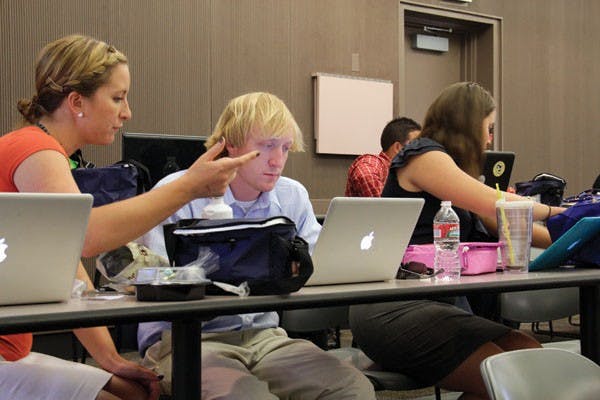 During a work-lunch for Teach For America on June 6, Megan Simpson, 26, and Nichols Plaskda, 25, work on their TFA assignments and tasks. (Photo by Shawn Raymundo)