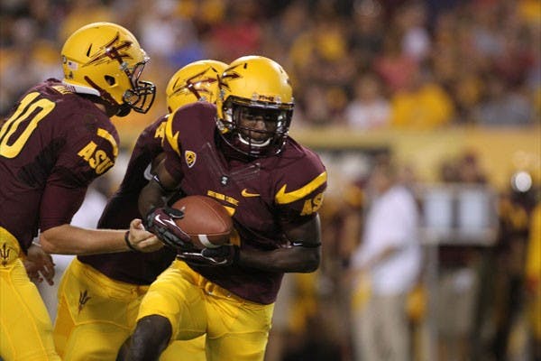 Redshirt sophomore defensive back Deantre Lewis receives a handoff from redshirt sophomore quarterback Taylor Kelly during the Sun Devils’ 63-6 win over NAU on Aug. 30. (Photo by Sam Rosenbaum)
