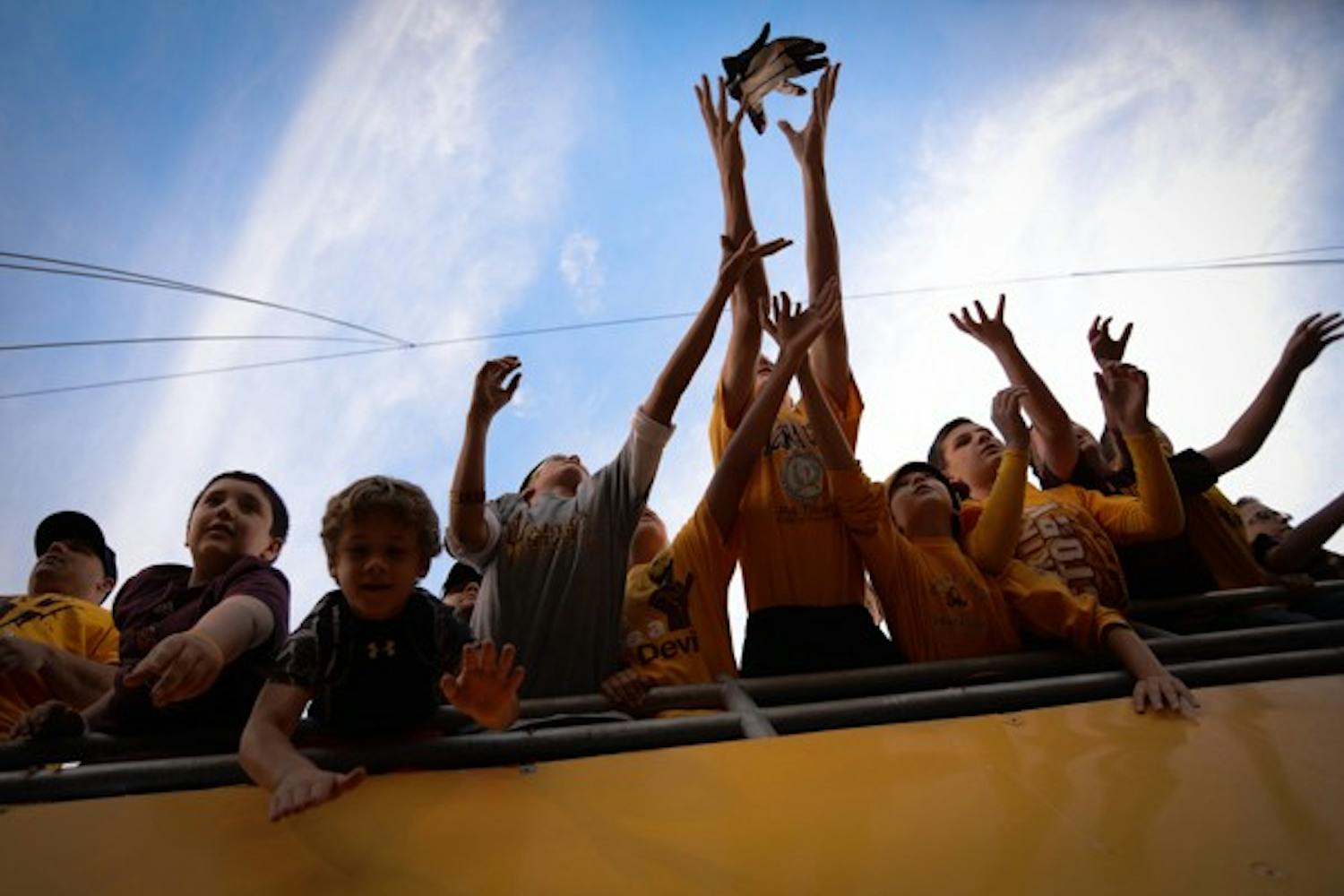 Young fans reach out for an ASU player's glove after Saturday's game. (Photo by Aaron Lavinsky)