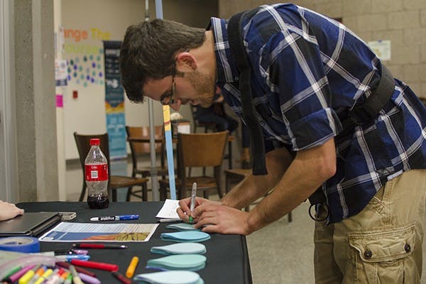 Wednesday, Nov. 12 - Nathan Francois (cq), a freshman studying biomedical engineering at Arizona State University, signs a pledge to conserve water as part of a larger campaign to restore 140 million gallons of water to the Colorado River. Photo by Ethan Fichtner.