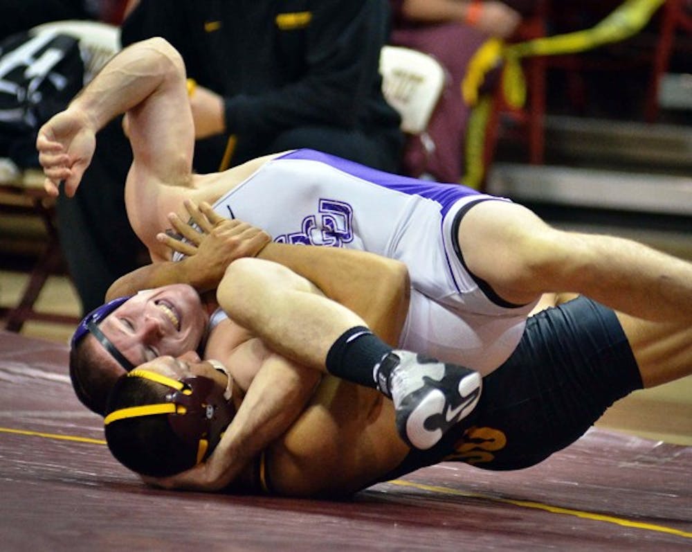 ASU senior Eric Starks wrestles with Grand Canyon University's Justin Martin on Nov. 13, 2011. Starks was one of only three Sun Devils to win a match last weekend in Oklahoma. (Photo by Aaron Lavinsky)