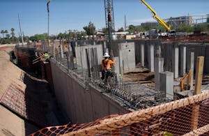 A construction worker makes crane cable adjustments on the site of ASU's new Biodesign C building on Tuesday, Nov. 1, 2016.