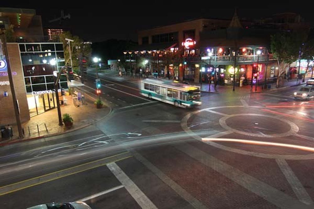 Car lights illuminate Mill Avenue late Wednesday night. Starting in 2014, the City of Tempe will construct a streetcar running along Mill Avenue.  (Photo by Ana Ramirez)