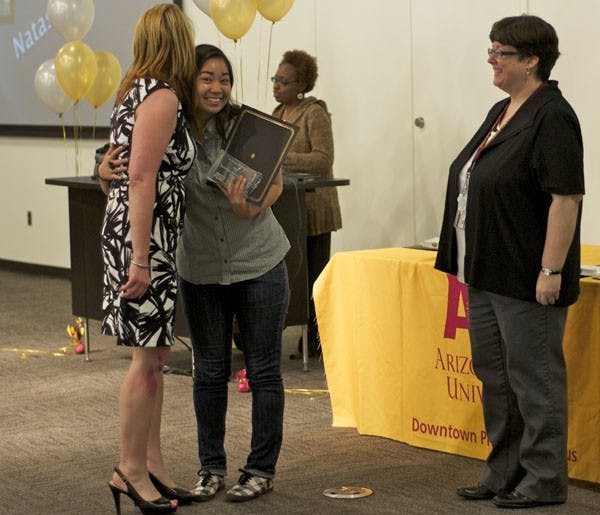 DISTINGUISHED DEVIL: Junior interdisciplinary studies major Natasia Cara Bongcas hugs the woman who nominated her, Lorrie Miller, as she accepts her award for Outstanding Student Employee at the Distinguished Devils Awards Ceremony on Wednesday. (Photo by Molly Smith)