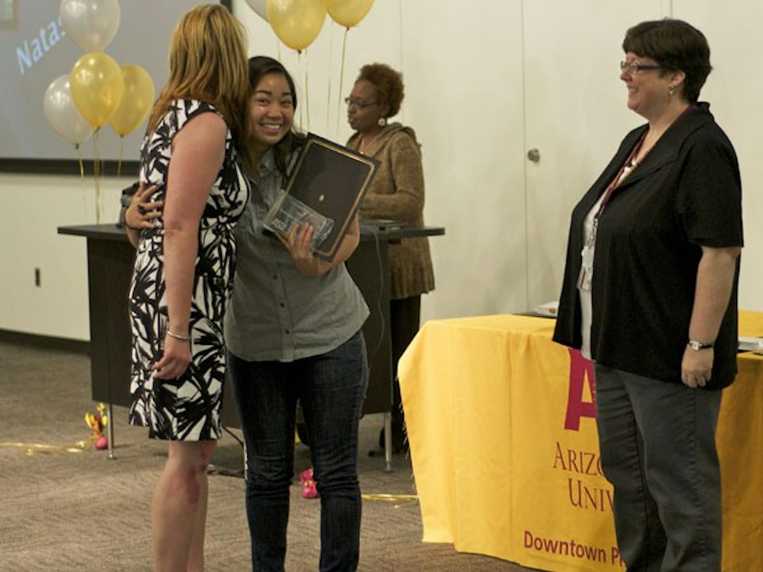 DISTINGUISHED DEVIL: Junior interdisciplinary studies major Natasia Cara Bongcas hugs the woman who nominated her, Lorrie Miller, as she accepts her award for Outstanding Student Employee at the Distinguished Devils Awards Ceremony on Wednesday. (Photo by Molly Smith)