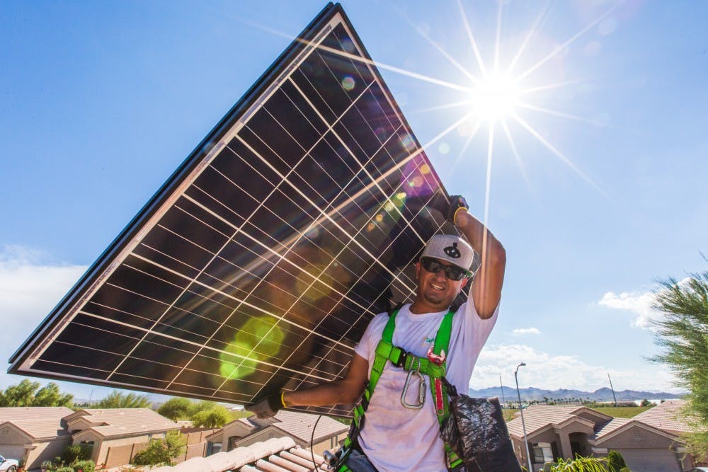 SolarCity employee mounts photovoltaic panel in Scottsdale, Arizona.