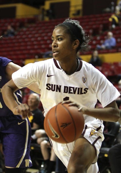 Freshman guard Arnecia Hawkins drives toward the basket against a Washington defender on Feb. 3. The women's basketball team hopes to get back on the right track at home against Utah and Colorado. (Photo by Molly J. Smith)
