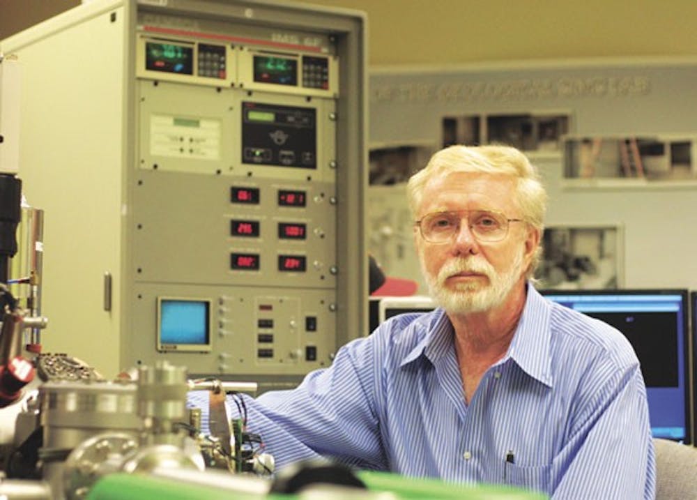 HEAVY MACHINERY: Chemistry Professor Dr. Peter Williams sits amidst a 1999 version of a Secondary Ion Mass Spectrometer or nano-scale. The chemistry department is scheduled to receive 1 of the 7 newest models this summer. (Photo by Serwaa Adu-Tutu)