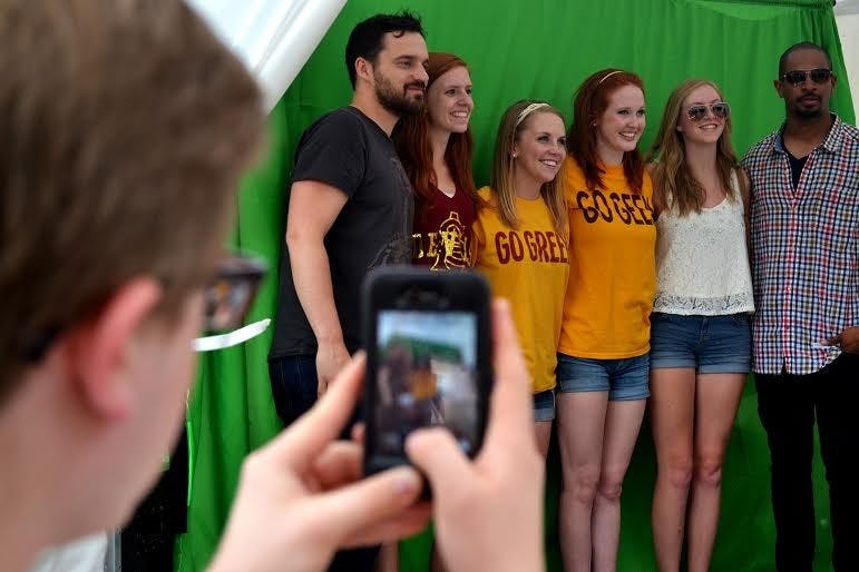 Trevor Thompson, 19, takes a photo of ASU students posing with Jake Johnson and Damon Wayans Jr. on Friday in front of the Memorial Union. The actors visited Tempe to promote their new movie "Let's Be Cops." (Photo by Lorraine Longhi)