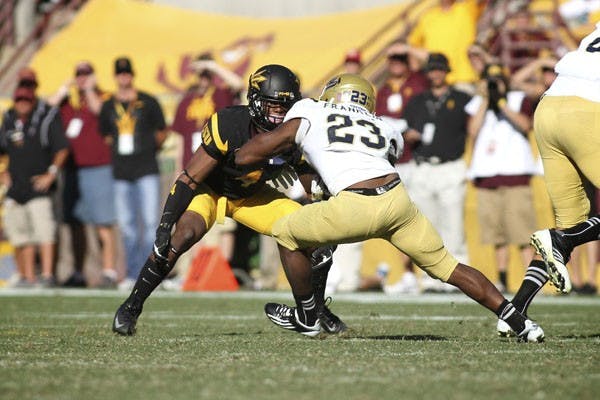 Junior safety Alden Darby stands in UCLA redshirt senior running back Johnathan Franklin’s way during the Sun Devils’ 45-43 loss to UCLA on Oct. 27. (Photo by Sam Rosenbaum)