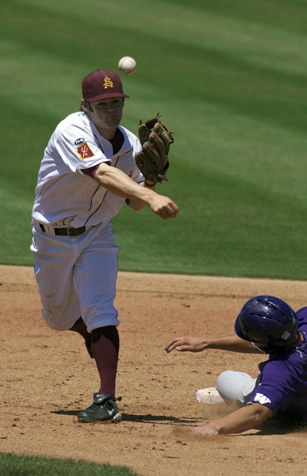 DOUBLE THE FUN: Sophomore second baseman Zack MacPhee turns a double play in the Sun Devils’ 10-4 win over Washington on Sunday at Packard Stadium. ASU won two of three games on the weekend to stay in first place in the Pac-10. (Photo By Scott Stuk)