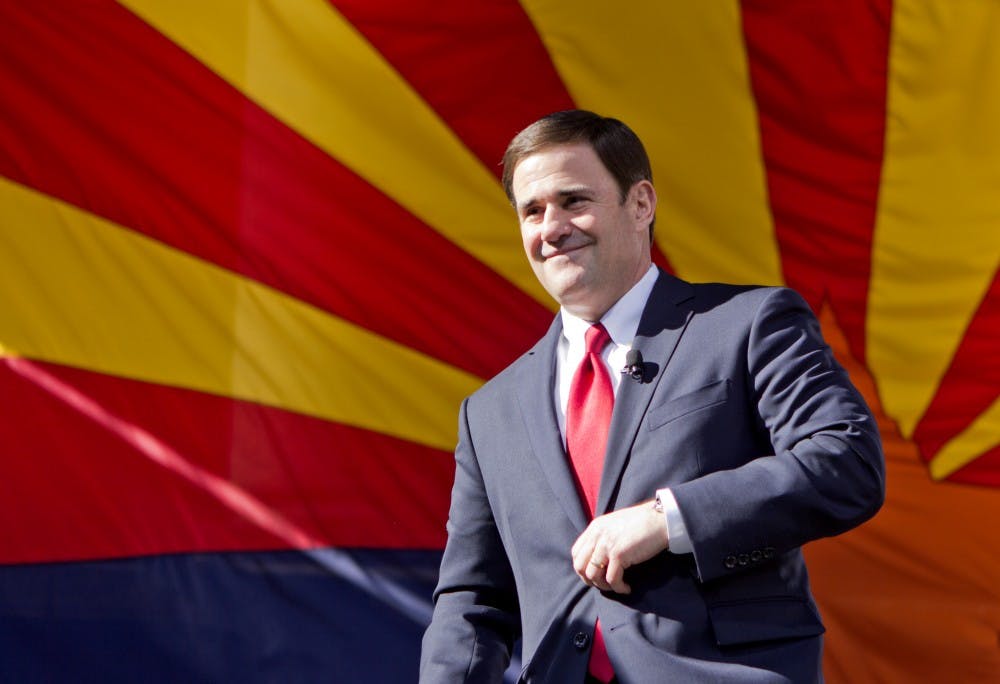 Gov. Doug Ducey walks on stage to take his oath of office at the state Capitol courtyard on Jan. 5, 2015.
