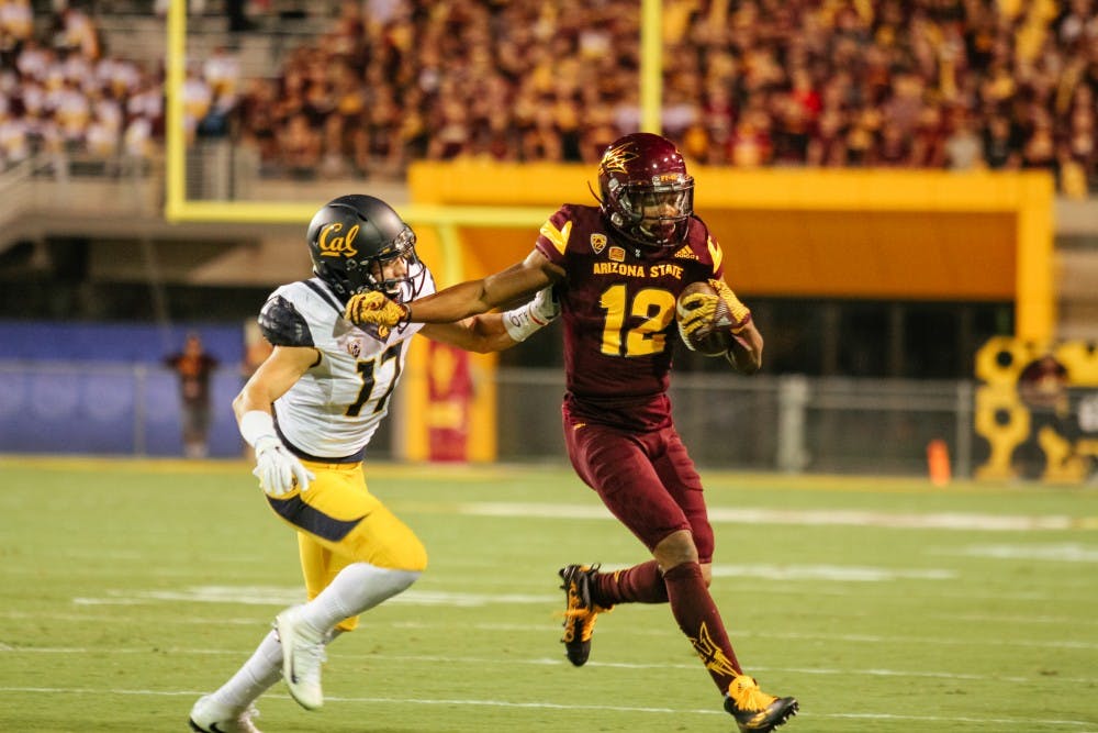 ASU wide receiver, Tim White (12) fends of a tackle during the first half of the football game versus the California Golden Bears in Tempe, Arizona, on Saturday, Sept. 24, 2016.