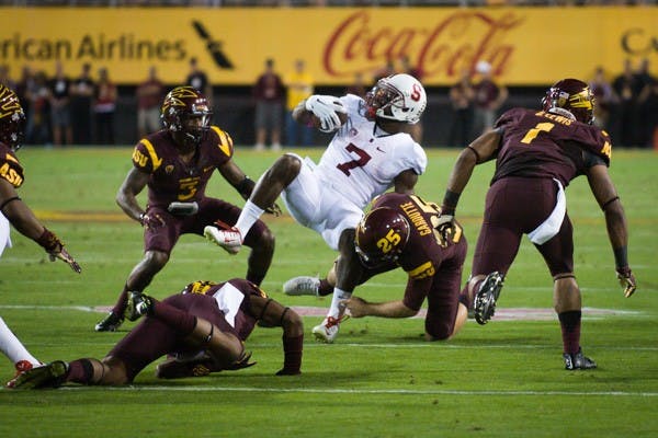 Redshirt senior Alex Garoutte tackles Stanford wide receiver Ty Montgomery on a punt return. (Photo by Andrew Ybanez)