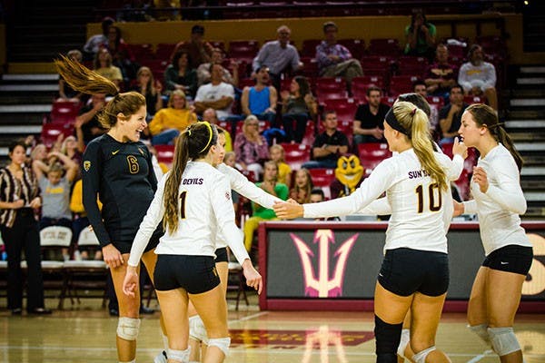 ASU volleyball teammates celebrate after a kill during a home game at Wells Fargo Arena in November 2013. (Photo by Andrew Ybanez)