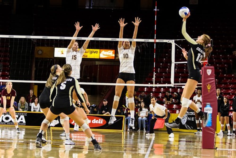 Sophomore outside hitter Kizzy Wiley and junior middle blocker Andi Lowrance go up to block against a Colorado roll shot during the game against Colorado on November 2nd, 2014. The Sun Devils' late comeback attempt came up short vs the Buffs as they lost 3-2. (Photo by Daniel Kwon)