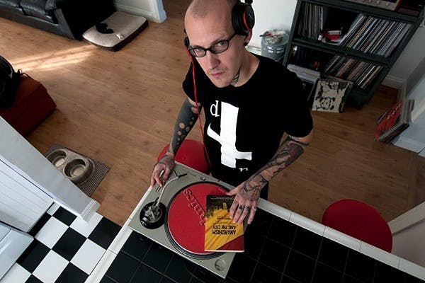 Disc jockey, producer and ASU associate teacher, Rob Poe drops the needle on his favorite political book. Poe teaches justice studies during the week and spins vinyl on the weekends. (Photo by Mario Mendez)