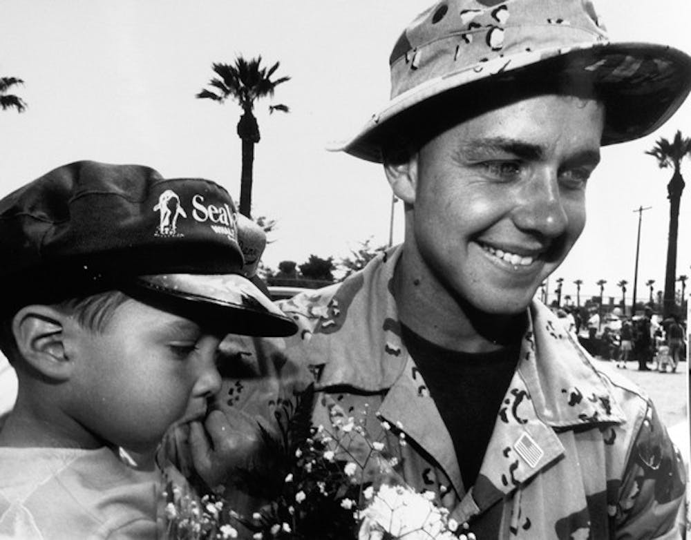 WELCOME HOME: Civil engineering major Lance Corporal Noel Collier is greeted by his three-year-old nephew Jordan Garcia in 1991. Collier was in the gulf for six months. (Photo by Irwin Daugherty)