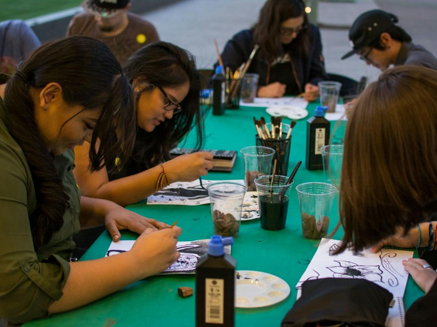 Students gather at an activity table outside the Phoenix Art Museum on Wednesday, March 29, 2017 and create art as part of the museums first-ever College Night. 
