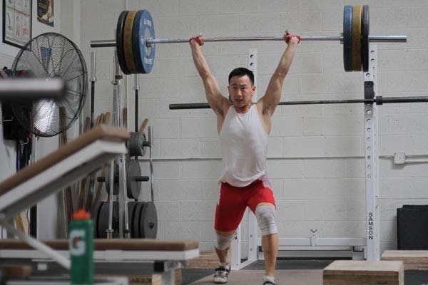 WEIGHT OF THE WORLDS: ASU junior Alex Lee trains at Performance One Advanced Sports Training in Mesa. Lee will compete for Team USA at the World Weightlifting Championships in Turkey beginning Friday. (Photo by Andy Jeffreys)