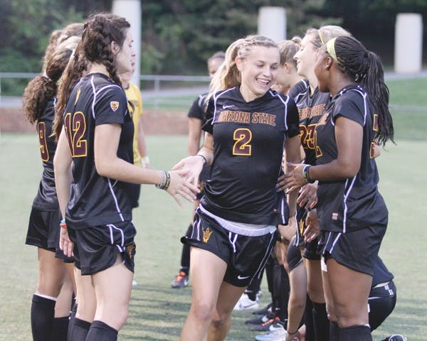 NEVER TOO EARLY: ASU freshman forward Alexandra Doller low-fives her teammates during pregame introductions before the Sun Devils’ clash with Virginia on Friday. Despite her youth, Doller has made an immediate impact on the team. (Photo courtesy of Steve Rodriguez)