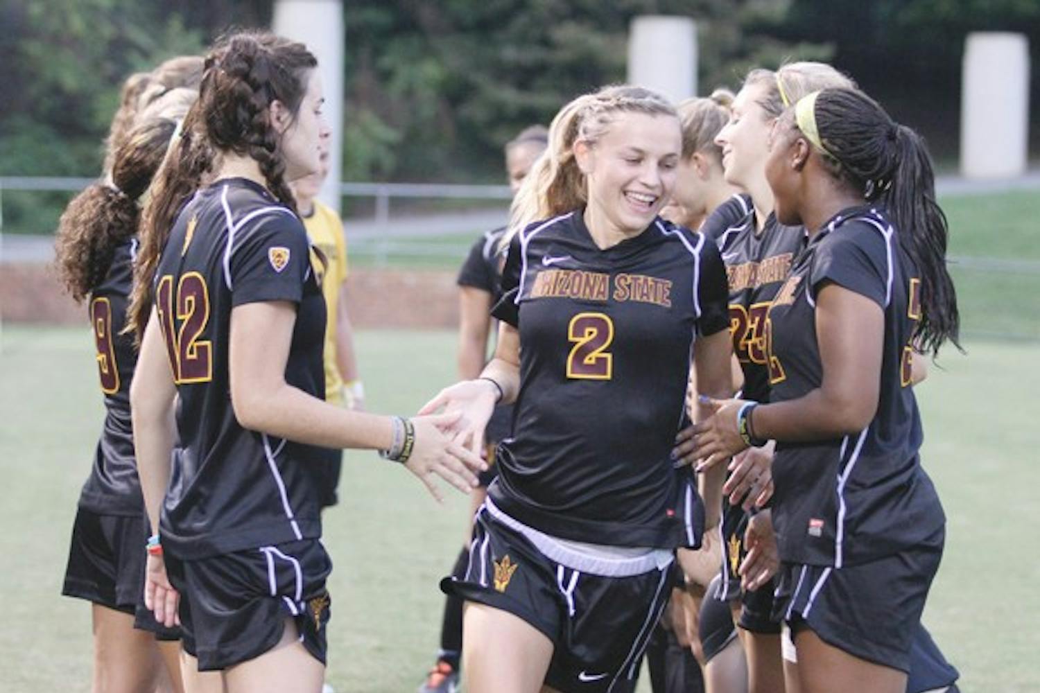 NEVER TOO EARLY: ASU freshman forward Alexandra Doller low-fives her teammates during pregame introductions before the Sun Devils’ clash with Virginia on Friday. Despite her youth, Doller has made an immediate impact on the team. (Photo courtesy of Steve Rodriguez)