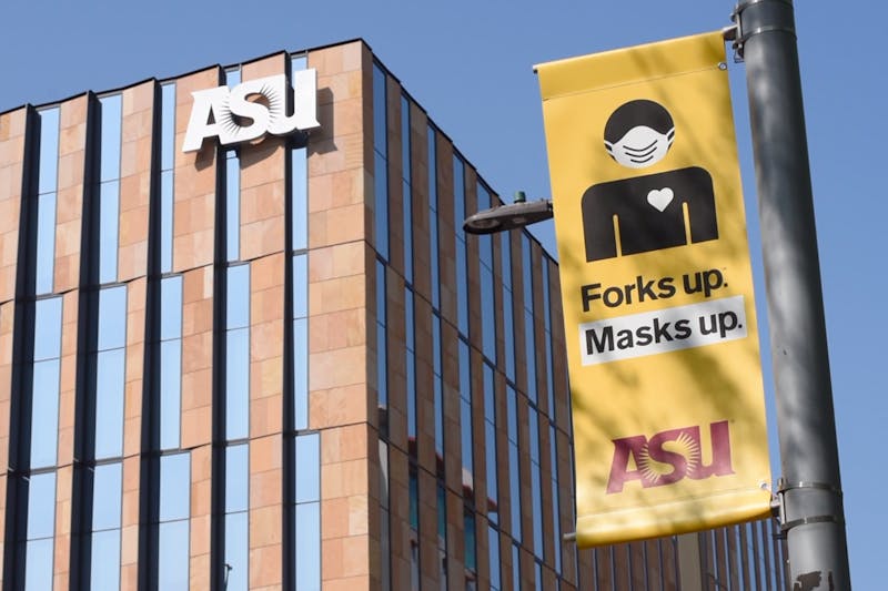 A 'Forks up masks up' sign is pictured. 