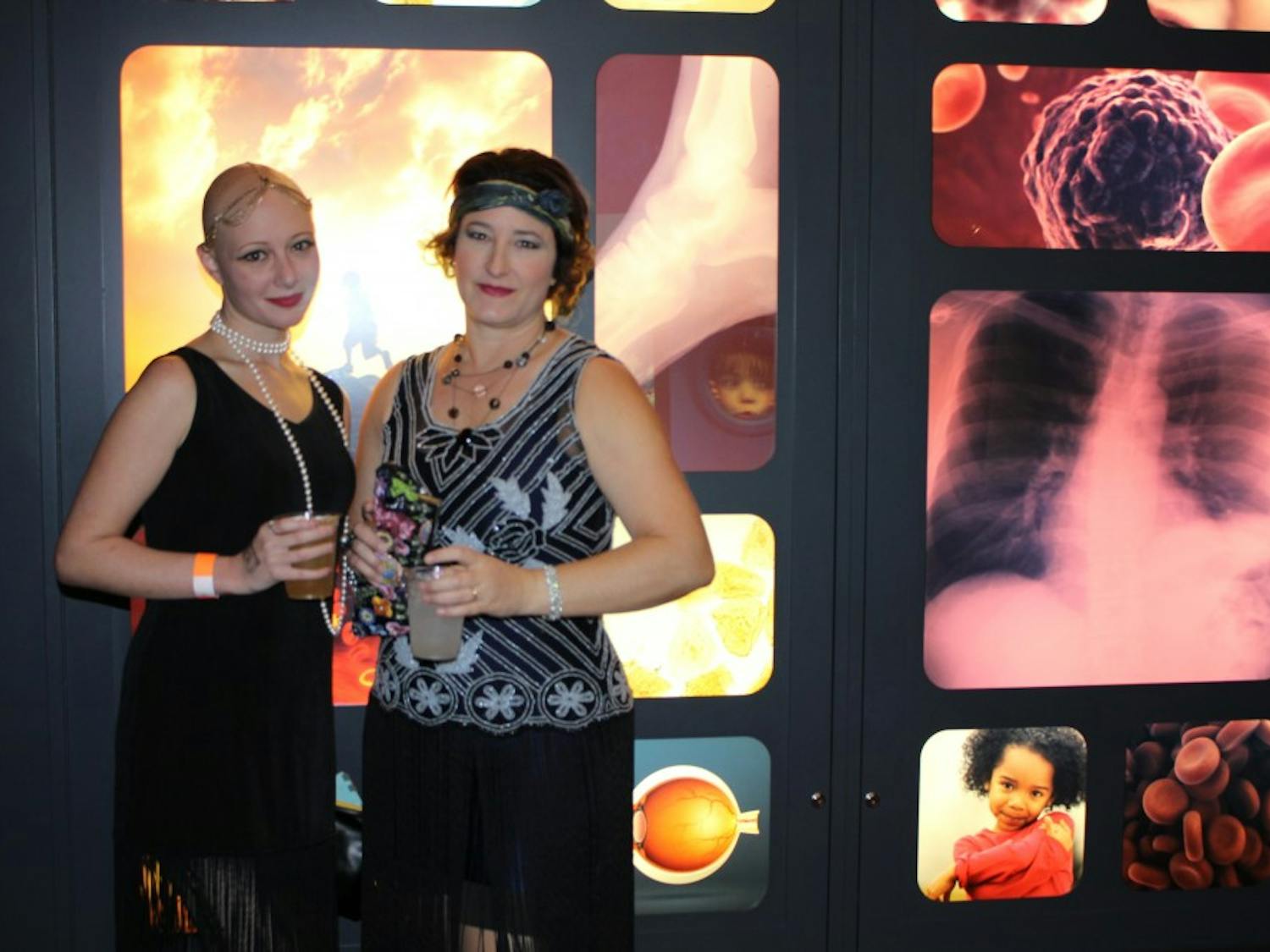 Rachel Sugihara, left, and Jenny Davie take part in Friday's 1920s-themed festivities at the Arizona Science Center.&nbsp;The monthly events are designed to engage local adults.