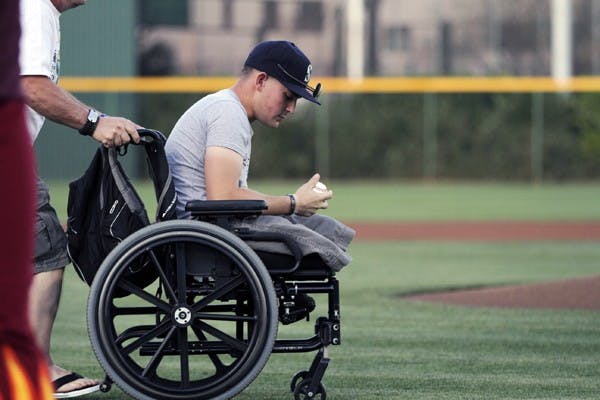 Cpt. Nick Kimmel looks at a baseball before he throws the first pitch in the ASU game against Utah Valley on March 13. Kimmel, a Purple Heart Marine, and several other Marines were honored before the Sun Devils’ 9–0 victory over the Wolverines. (Photo by Sam Rosenbaum)