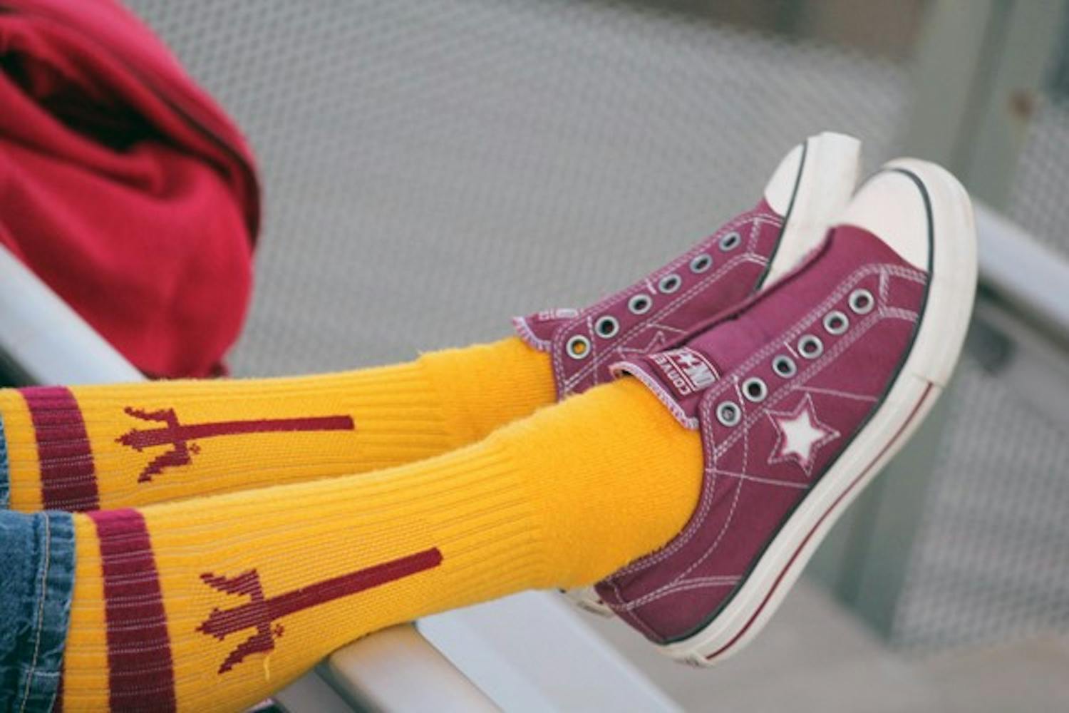A fan props her legs up on a rail during ASU softball's game against Central Connecticut on Saturday. (Photo courtesy of Justin Marshall)