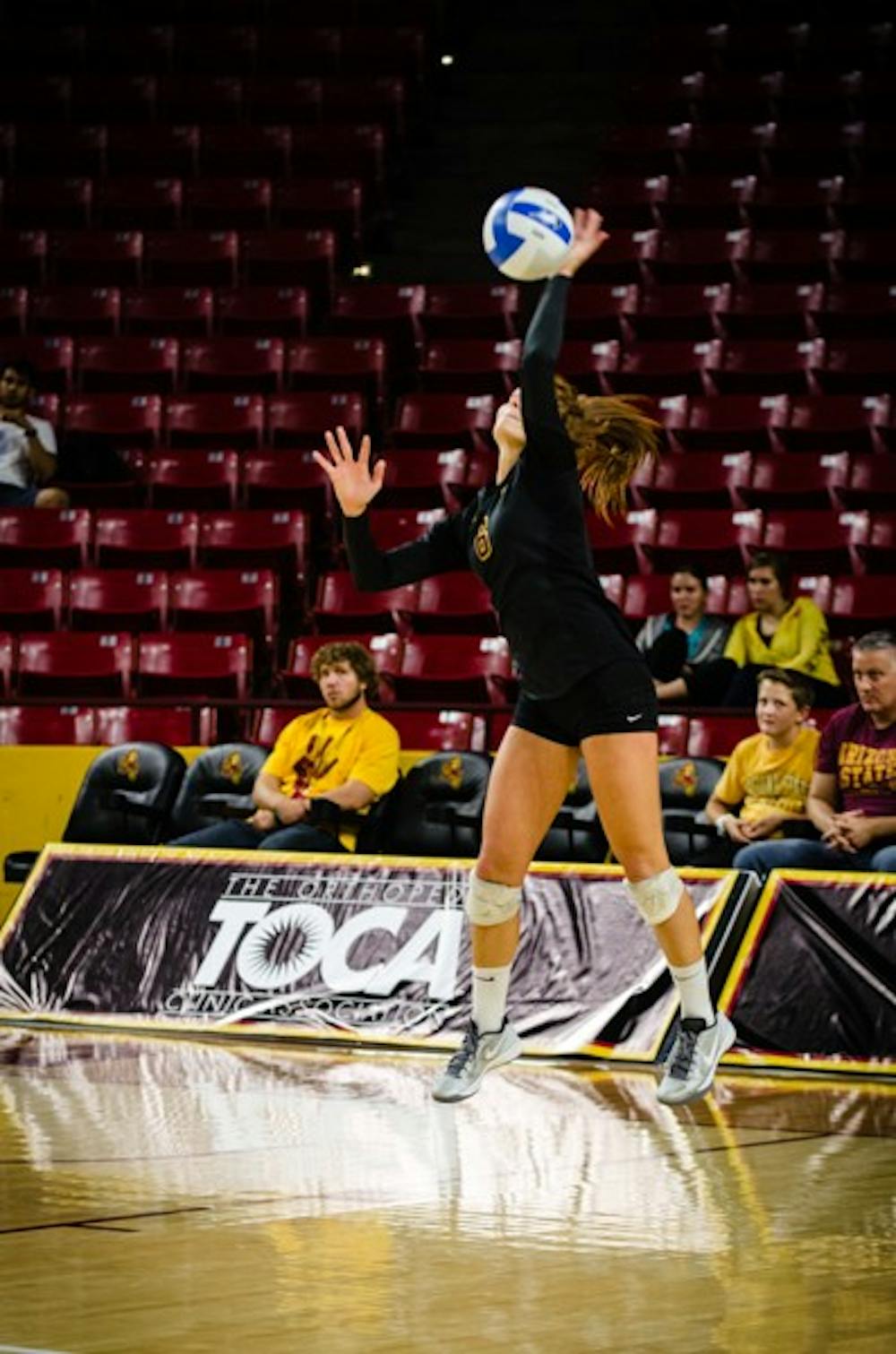 Senior libero Stephanie Preach serves at a home game against Colorado on November 4th, 2013.  There is still a fierce competition to replace Preach at the libero spot for the 2014 season. (Photo by Andrew Ybanez)