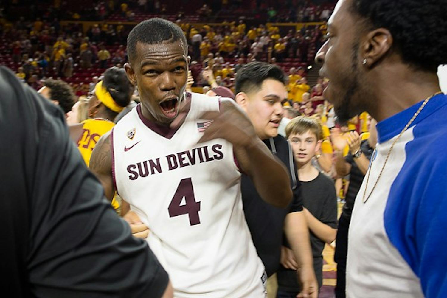 Junior guard Gerry Blakes celebrates with fans on the court after defeating Arizona 81-78, Saturday, Feb. 7, 2015 at Wells Fargo Arena in Tempe. (Shiva Balasubramanian/The State Press)