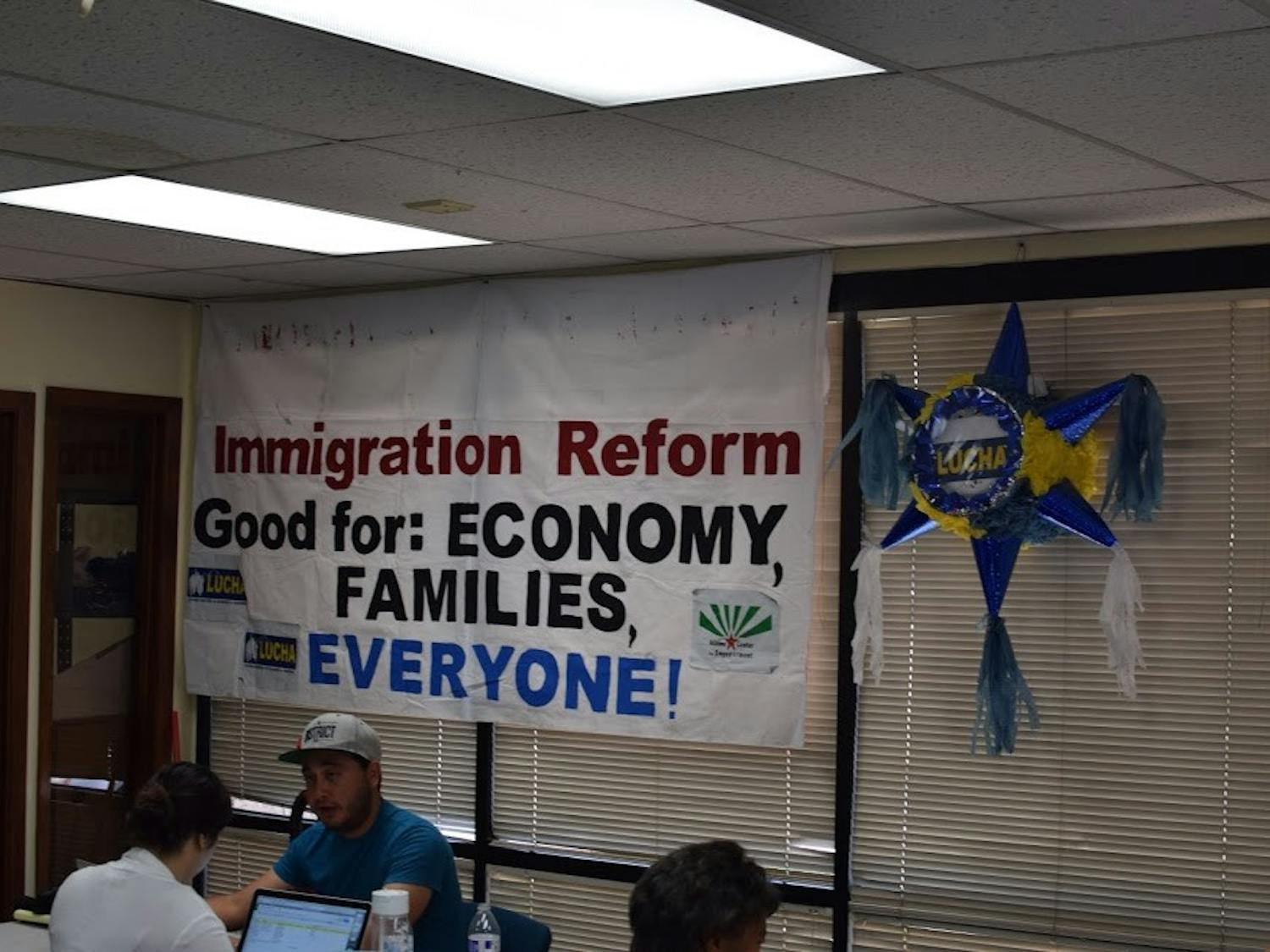 A&nbsp;sign reads "Immigration Reform Good for: Economy, Families, everyone" inside the LUCHA minimum wage campaign room.&nbsp;