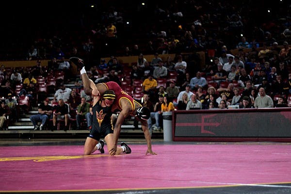 Redshirt sophomore Blake Stauffer wrestles ISU redshirt freshman Lelund Weatherspoon at a home meet on Feb. 1, 2014. (Photo by Alexis Macklin)