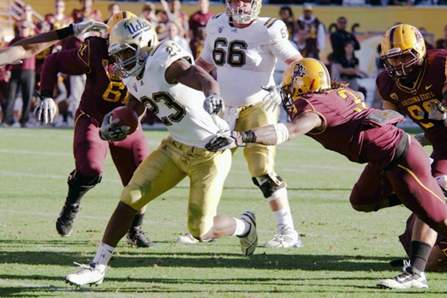 GREAT LENGTHS: Redshirt senior cornerback Omar Bolden reaches for a tackle against UCLA junior fullback Damien Thigpen in the Sun Devils’ meeting against the Bruins last November. Bolden’s return from an ACL tear remains uncertain despite speculation of a comeback that surfaced earlier this week. (Photo by Aaron Lavinsky)