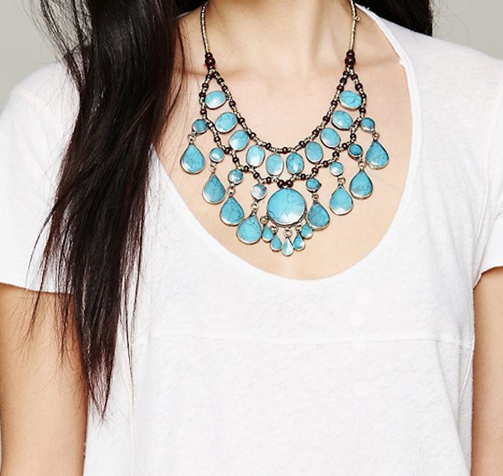 Wear a bold necklace to make a plain white t-shirt stand out. Photo courtesy Free People

