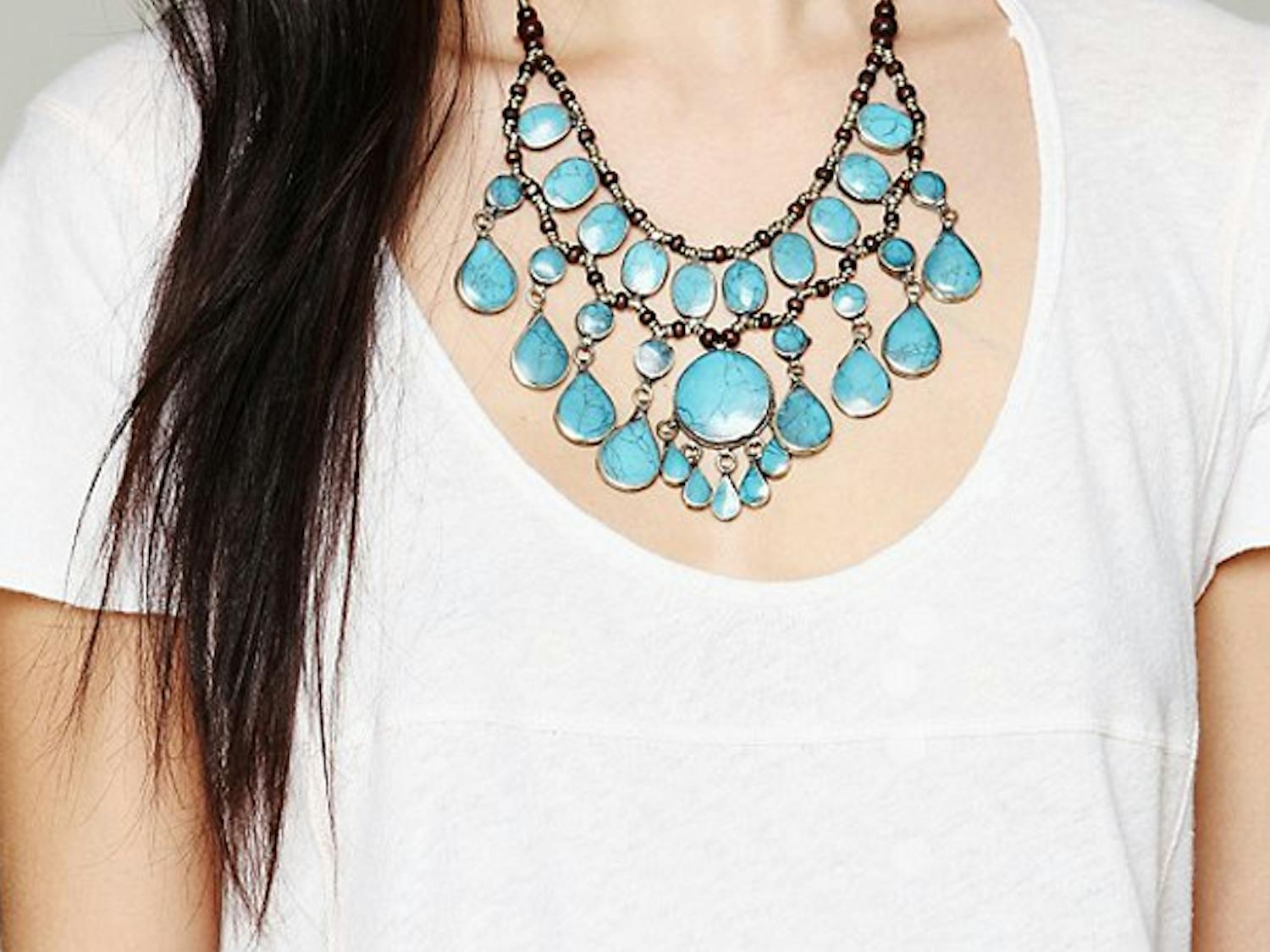 Wear a bold necklace to make a plain white t-shirt stand out. Photo courtesy Free People


