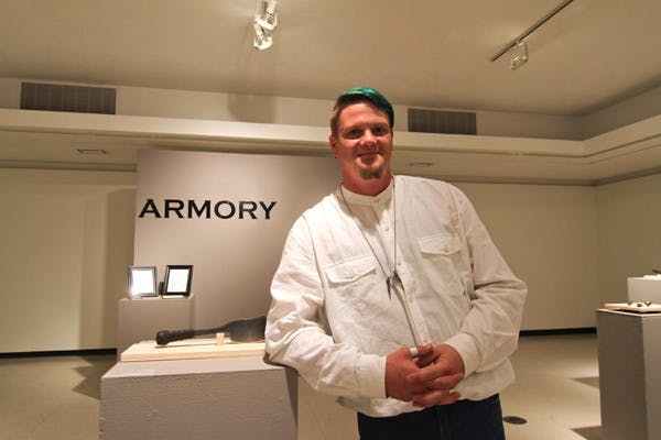 Erik Bogner poses in the Harry Wood Gallery on the Tempe campus, where his "Armory" exhibition opened Monday. The display features edged weaponry inspired by history and folklore. (Photo by Lisa Bartoli)