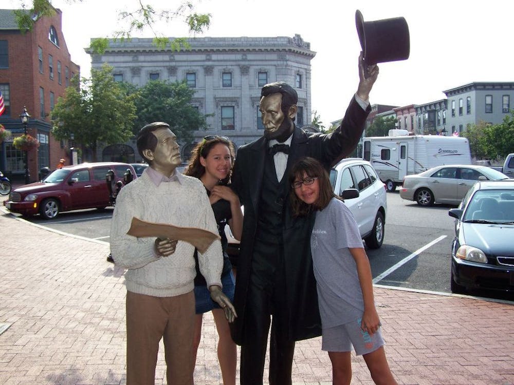 Holly and her sister, Emily, pose with a statue of their favorite President.