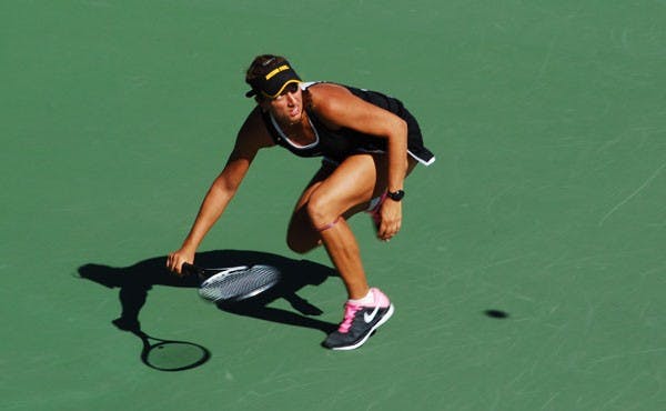 Senior Jacqueline Cako crouches down to return a lofted shot against Pepperdine on Feb. 23. The ASU tennis team continued their Pac-12 dominance this past weekend sweeping Washington and Washington State. (Photo by Murphy Bannerman)