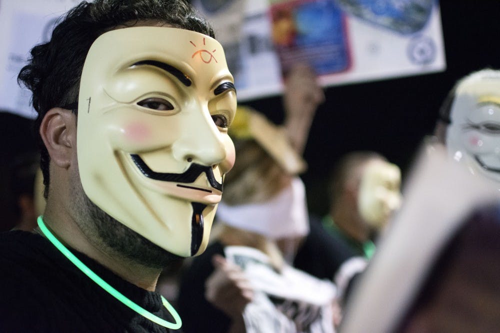 A protestor participates in the Million Mask March held by Arizona Anonymous in Downtown Phoenix on Friday, Nov. 4, 2016.