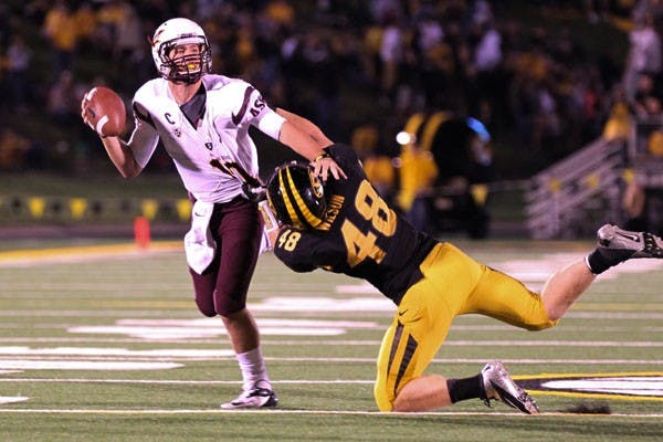 Redshirt sophomore quarterback Taylor Kelly (left) looks for an open receiver over Missouri redshirt junior linebacker Andrew Wilson during the Sun Devils’ 24-20 loss against the Tigers on Saturday. (Photo courtesy of Danielle Kasper of The Daily Maneater)
