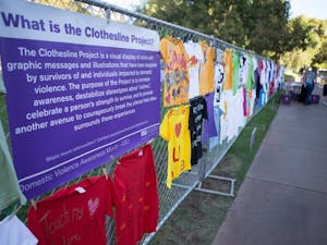 T-shirts with heartwarming messages that are part of the Clothesline Project are displayed at Hayden Lawn. One of the goals of the project is to destabilize stereotypes about victims and celebrate a person’s strength to survive. (Photo by Ryan Liu)